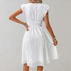 Lightweight summer dress in soft pink with flutter sleeves, perfect for casual outings. 4