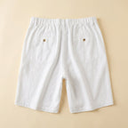 Light beige linen shorts with a relaxed fit and drawstring closure, perfect for casual summer wear. 4