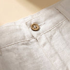Light beige linen shorts with a relaxed fit and drawstring closure, perfect for casual summer wear. 6