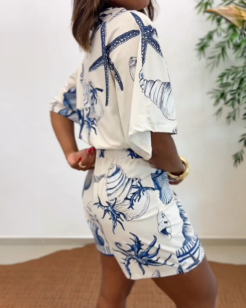 Light blue women's romper featuring a starfish and seashell print, designed with batwing sleeves for a relaxed fit. 1