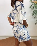 Light blue women's romper featuring a starfish and seashell print, designed with batwing sleeves for a relaxed fit. 1