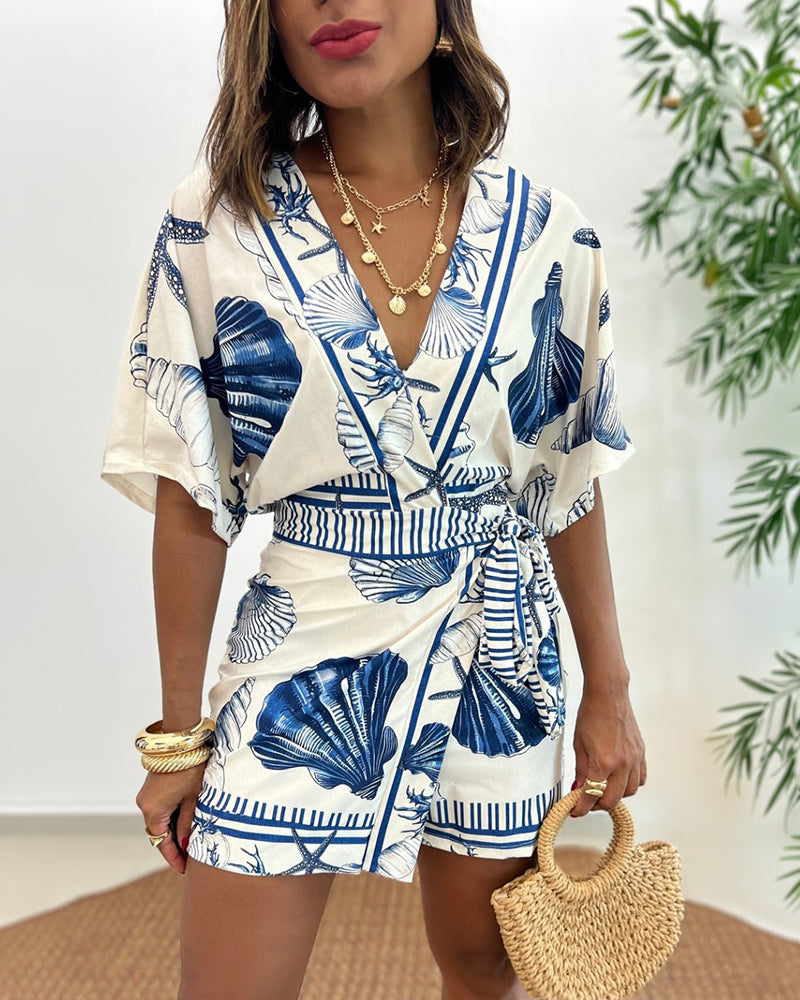 Light blue women's romper featuring a starfish and seashell print, designed with batwing sleeves for a relaxed fit. 2