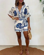Light blue women's romper featuring a starfish and seashell print, designed with batwing sleeves for a relaxed fit. 3