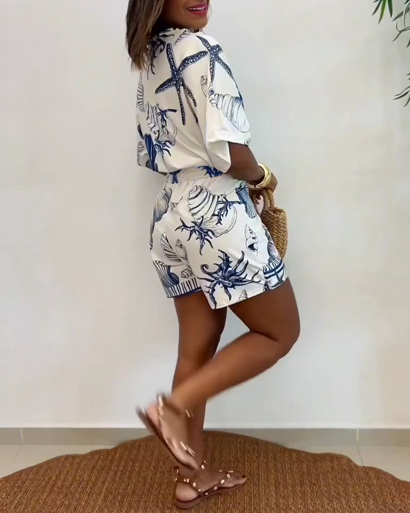 Light blue women's romper featuring a starfish and seashell print, designed with batwing sleeves for a relaxed fit. 4