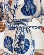 Light blue women's romper featuring a starfish and seashell print, designed with batwing sleeves for a relaxed fit. 6
