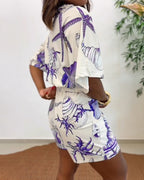 Light blue women's romper featuring a starfish and seashell print, designed with batwing sleeves for a relaxed fit. 8