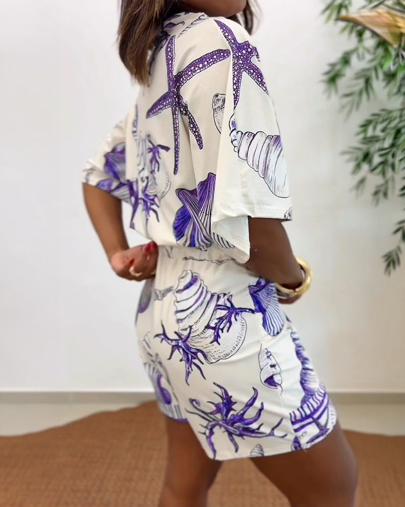 Light blue women's romper featuring a starfish and seashell print, designed with batwing sleeves for a relaxed fit. 8