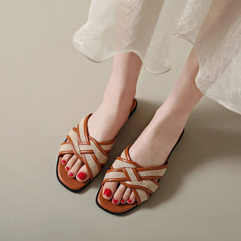 Tan woven flat slides with a casual, bohemian style perfect for relaxed summer outings. 0