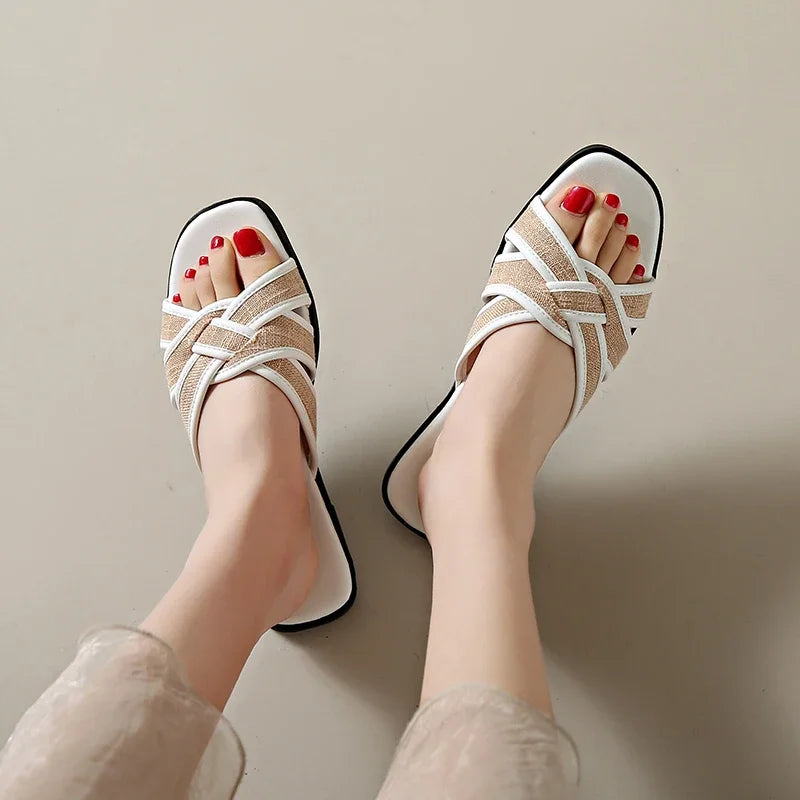 Tan woven flat slides with a casual, bohemian style perfect for relaxed summer outings. 3