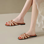 Tan woven flat slides with a casual, bohemian style perfect for relaxed summer outings. 5