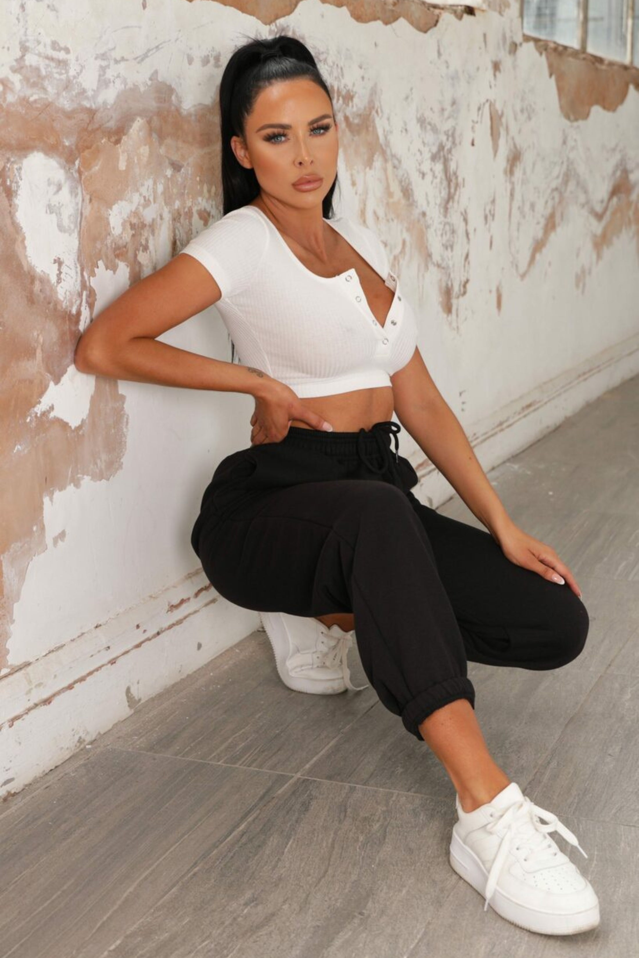 Black joggers with cuffed hems and an elasticated waist, featuring a relaxed and casual style. 2
