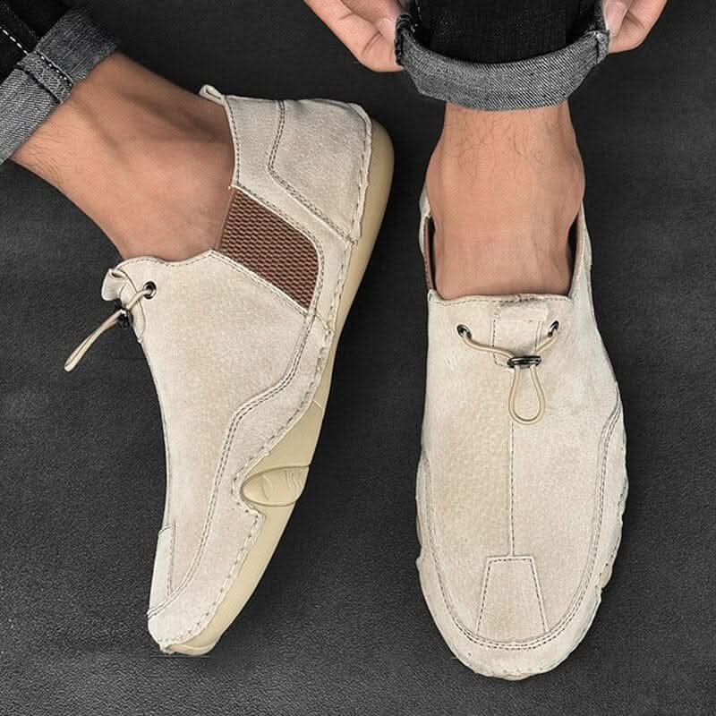 Brown leather slip-ons with elastic lacing and a non-slip sole, featuring a sleek and casual design. 0