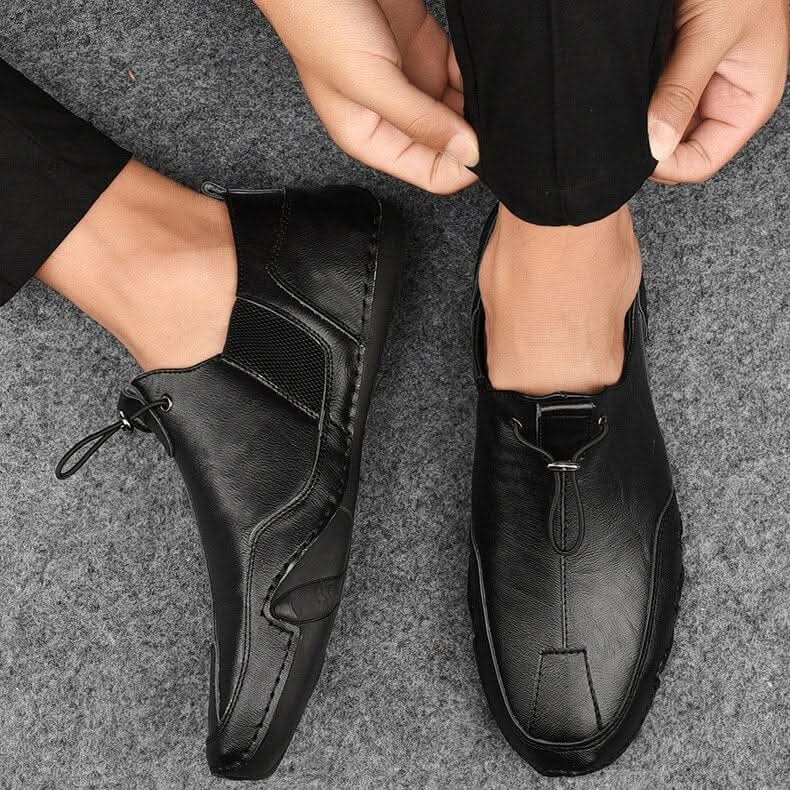 Brown leather slip-ons with elastic lacing and a non-slip sole, featuring a sleek and casual design. 2