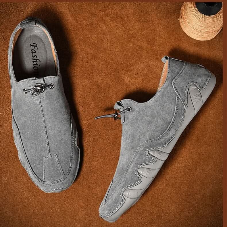 Brown leather slip-ons with elastic lacing and a non-slip sole, featuring a sleek and casual design. 4