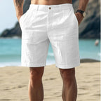Light beige linen shorts in a relaxed, casual style perfect for warm weather outings. 0