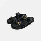 Elegant tan leather sandals for women, featuring a minimalist design with a comfortable flat sole. 1