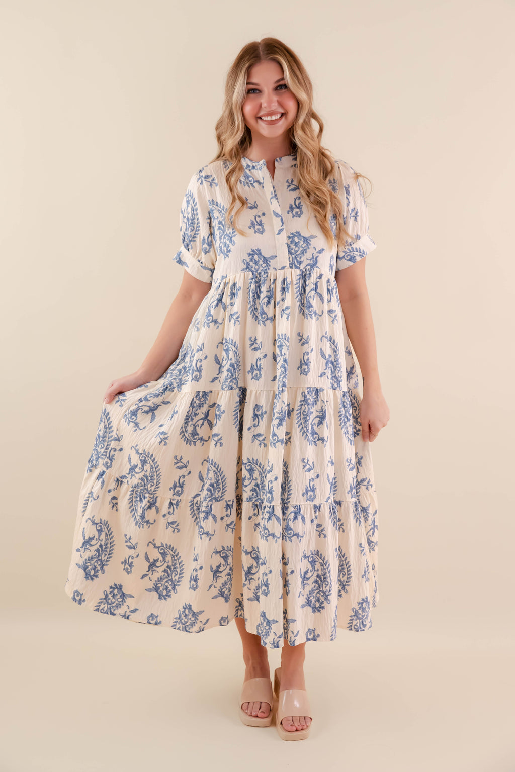 A blue tiered midi dress with a relaxed fit, featuring a wavy pattern perfect for casual summer outings. 0