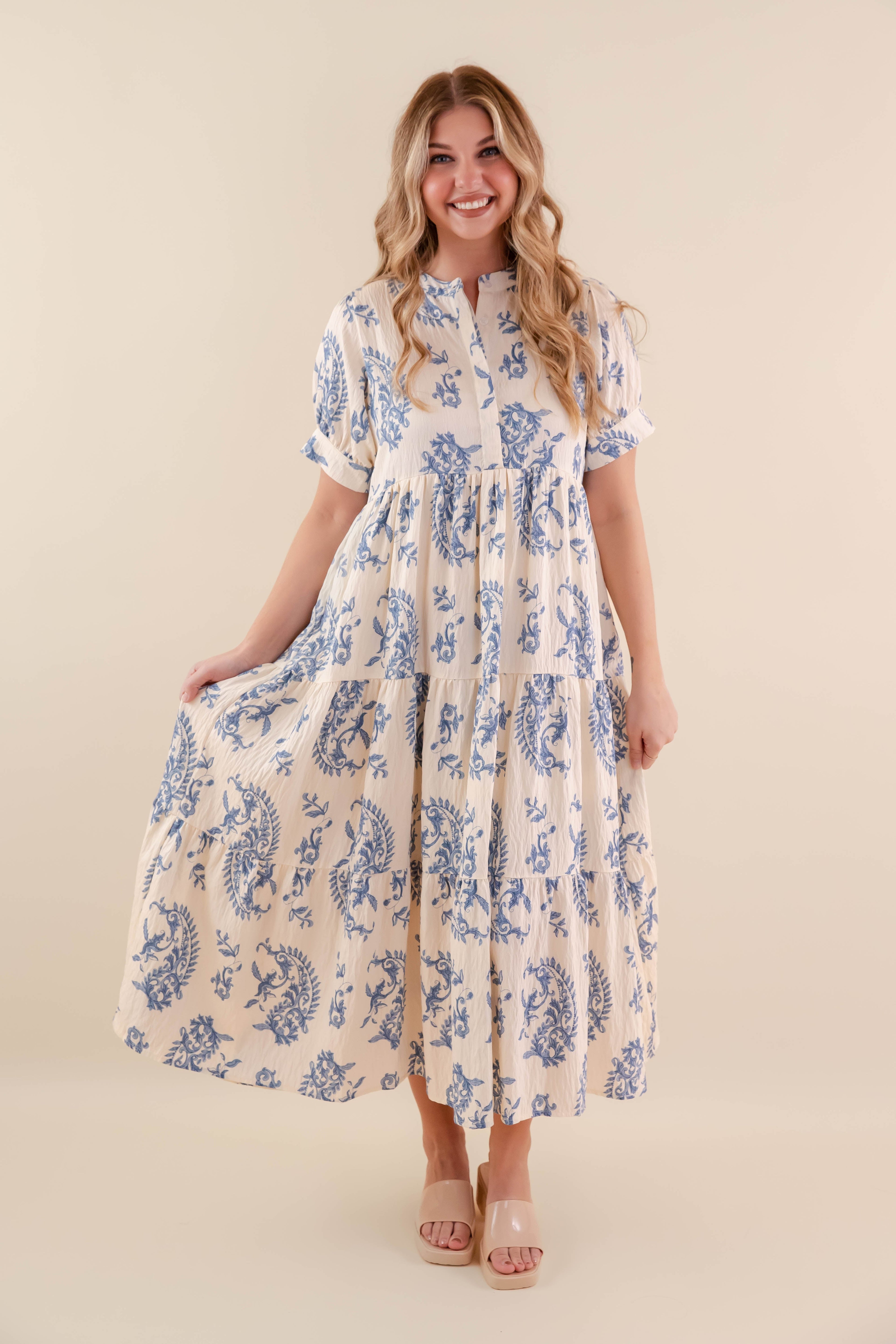 A blue tiered midi dress with a relaxed fit, featuring a wavy pattern perfect for casual summer outings. 0