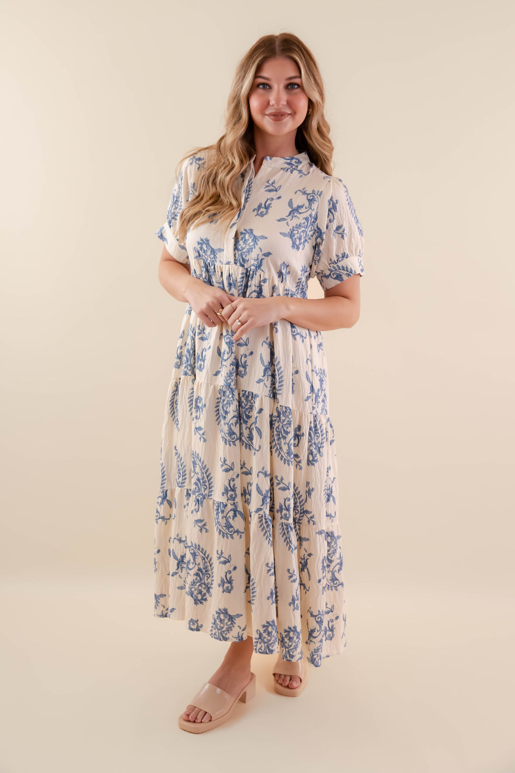 A blue tiered midi dress with a relaxed fit, featuring a wavy pattern perfect for casual summer outings. 2