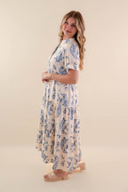 A blue tiered midi dress with a relaxed fit, featuring a wavy pattern perfect for casual summer outings. 3