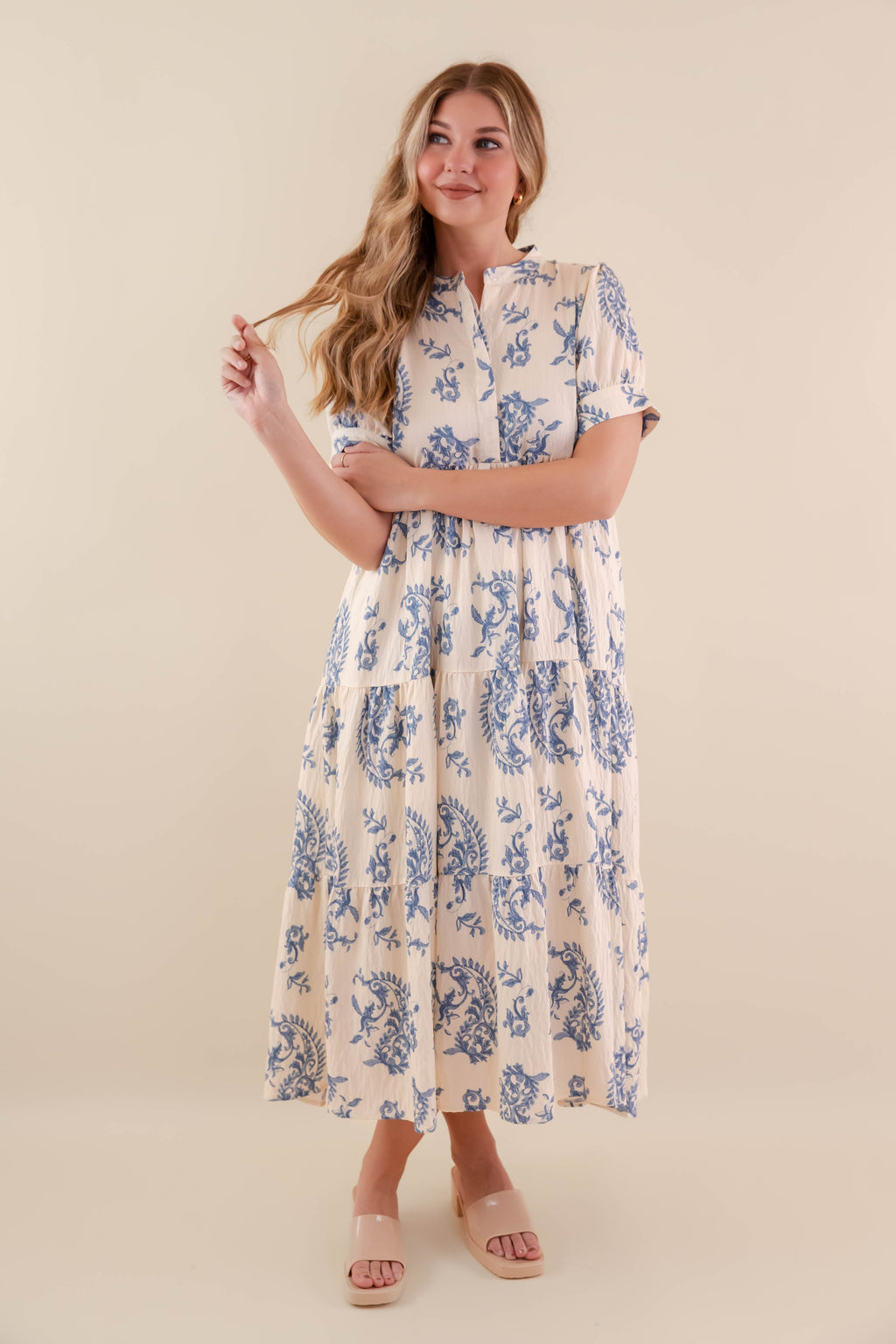A blue tiered midi dress with a relaxed fit, featuring a wavy pattern perfect for casual summer outings. 4