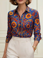 Floral print long sleeve blouse in soft cream with buttoned lapel, featuring a relaxed and feminine style. 1