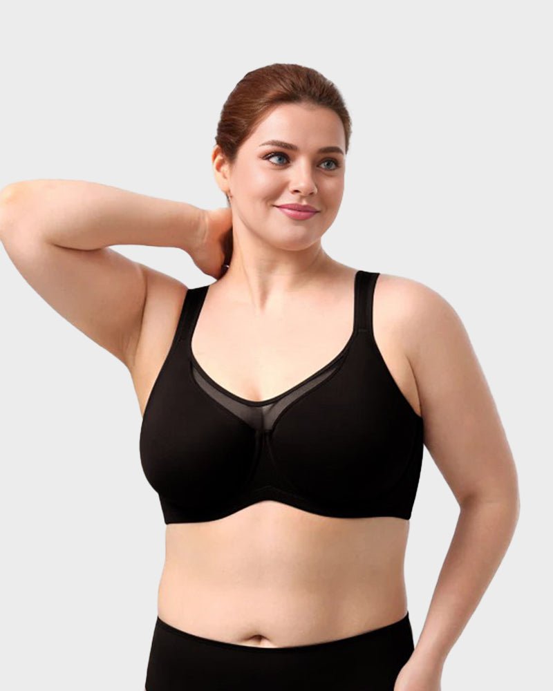 Marieke plus size minimizer bra in black, front view with arm raised