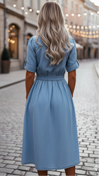 Light blue denim shirt dress with a belted waist, crisp collar, and side pockets, offering a casual yet polished look. 3