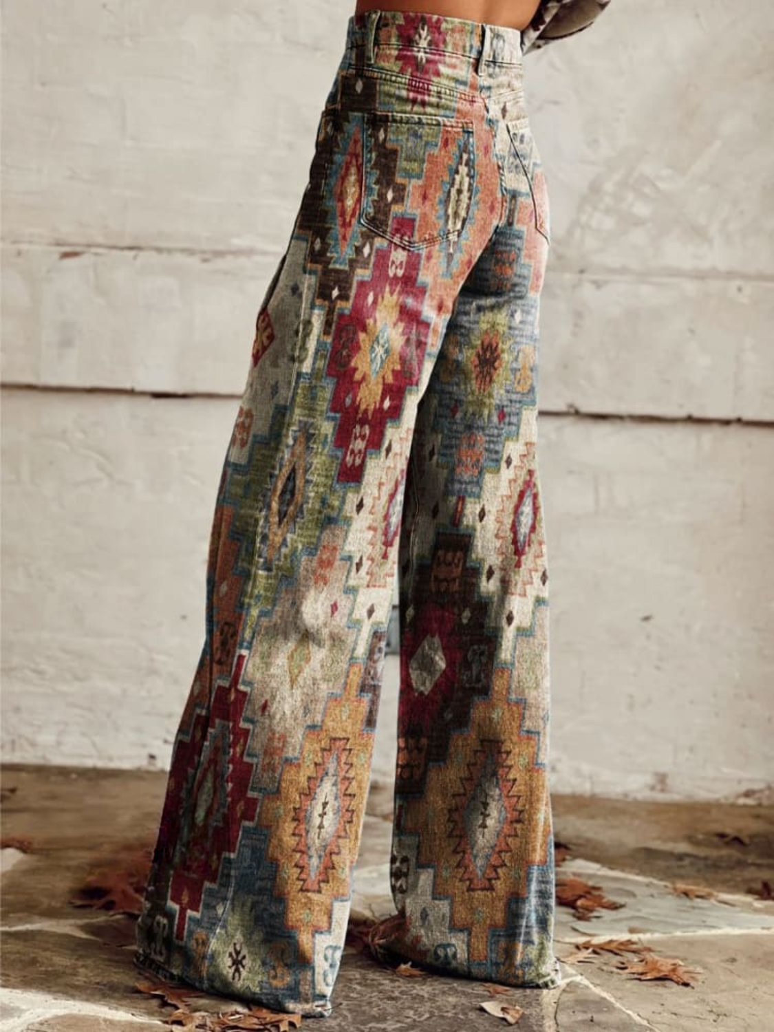 Maya wide leg pants featuring a chevron pattern in soft beige and cream tones, offering a relaxed and stylish look. 2