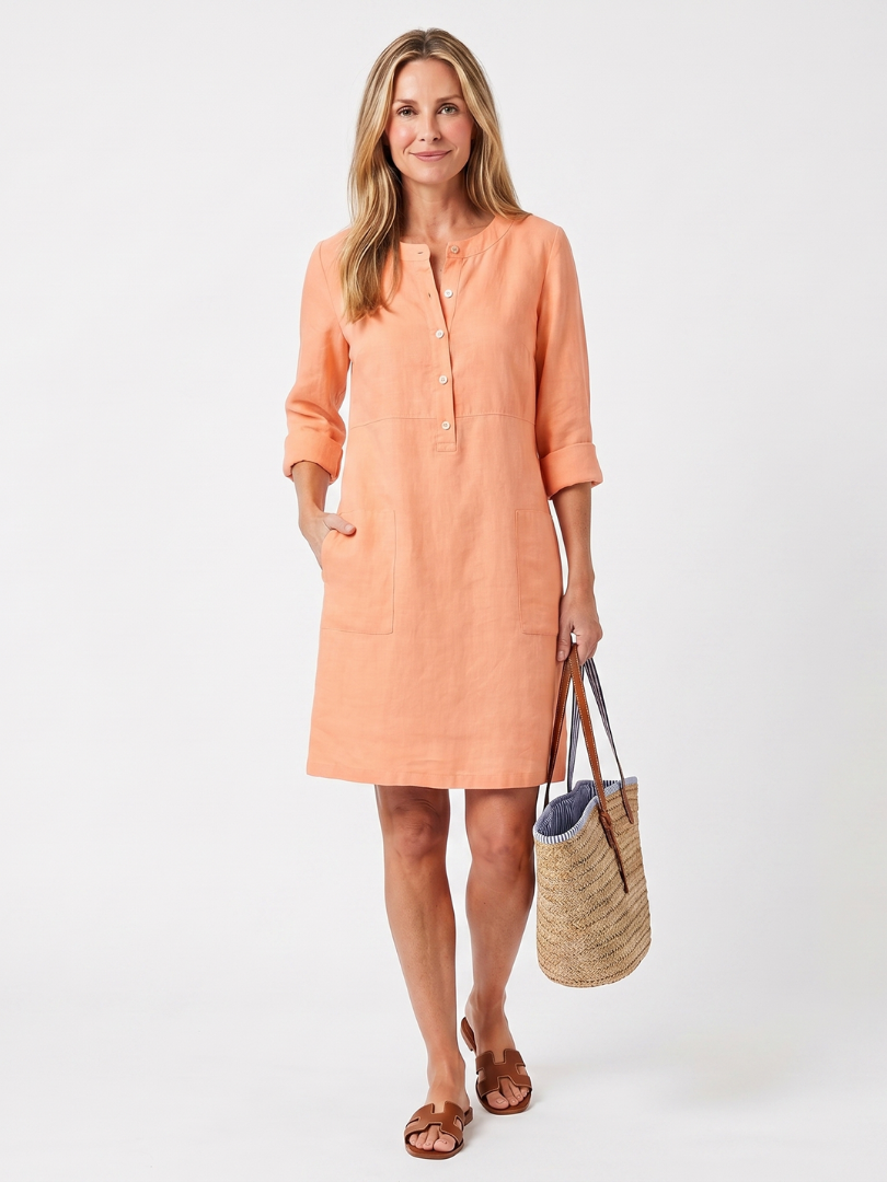 A knee-length dress in navy blue with a button front and three-quarter sleeves, showcasing a casual yet elegant style. 5