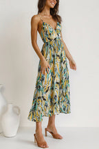 Mia summer dress in a vibrant floral print, featuring a V-neck and a relaxed sling style, made from a soft cotton blend. 8