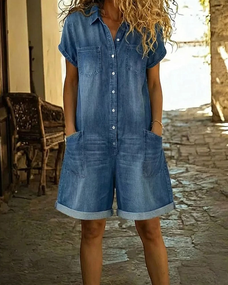 Light blue denim short sleeve jumpsuit with a relaxed fit and side pockets. Casual and comfortable style. 0