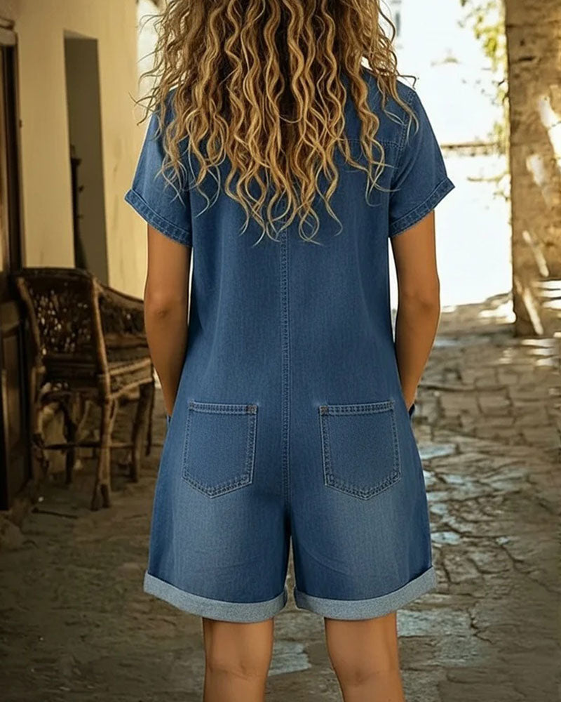 Light blue denim short sleeve jumpsuit with a relaxed fit and side pockets. Casual and comfortable style. 2