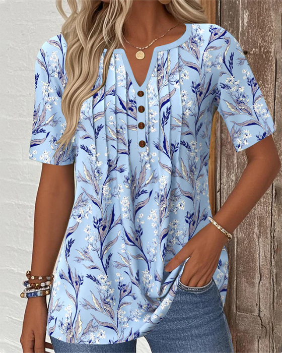 Floral print blouse in soft pastel colors, featuring a V-neck and short sleeves, made from a comfortable cotton blend. 1