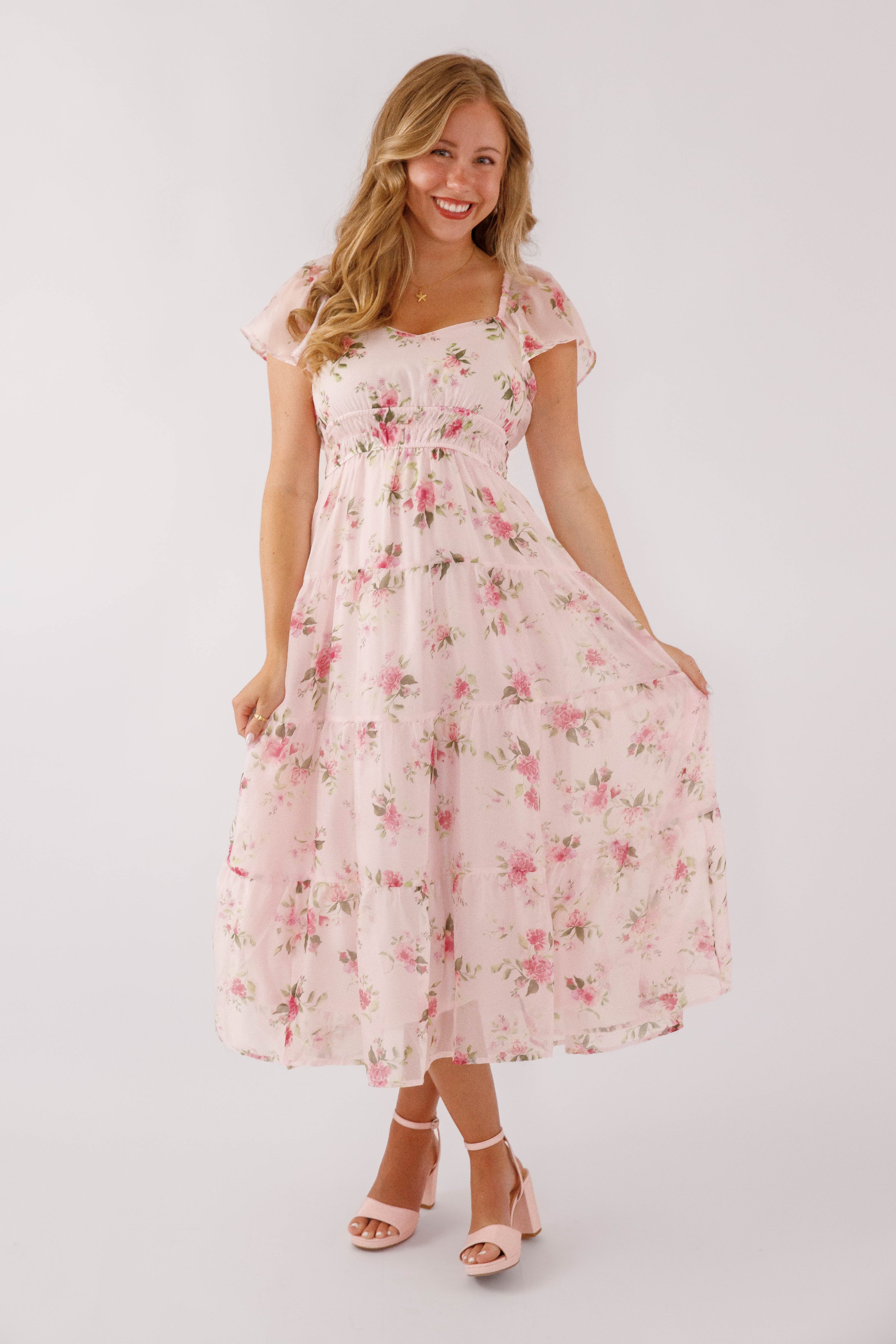 Blush pink midi dress with a floral pattern and flutter sleeves, perfect for wedding guests. 3
