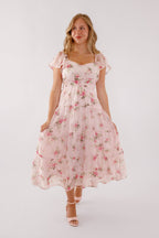 Blush pink midi dress with a floral pattern and flutter sleeves, perfect for wedding guests. 7