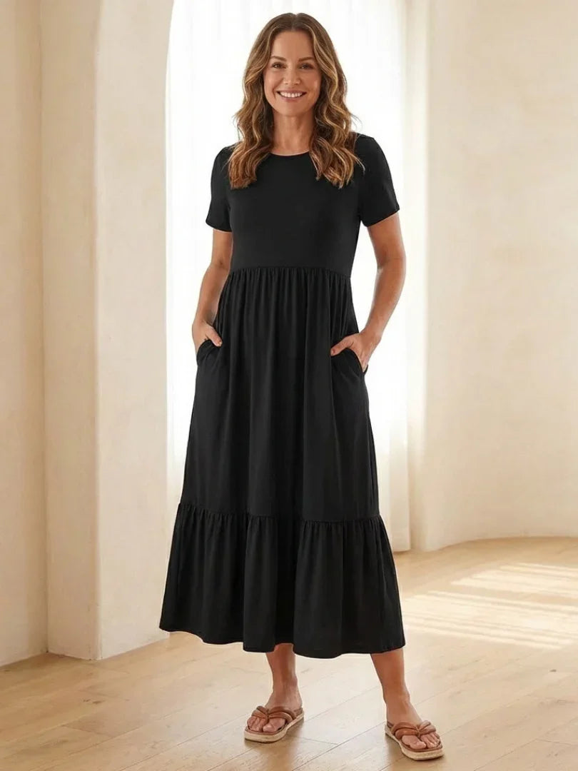 Nerissa round neck short sleeve tiered midi dress in soft blue cotton, featuring a relaxed fit and pockets. 0