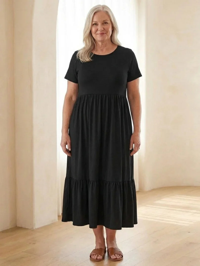 Nerissa round neck short sleeve tiered midi dress in soft blue cotton, featuring a relaxed fit and pockets. 1
