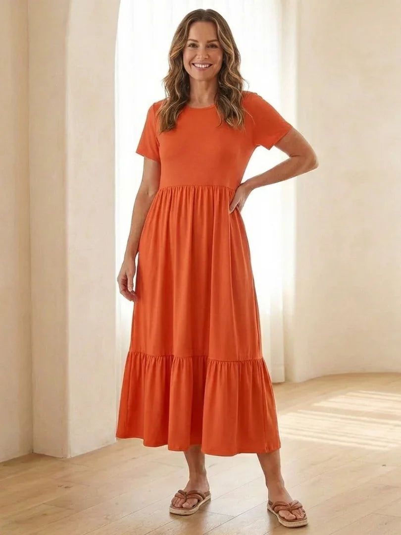 Nerissa round neck short sleeve tiered midi dress in soft blue cotton, featuring a relaxed fit and pockets. 2