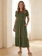 Nerissa round neck short sleeve tiered midi dress in soft blue cotton, featuring a relaxed fit and pockets. 4