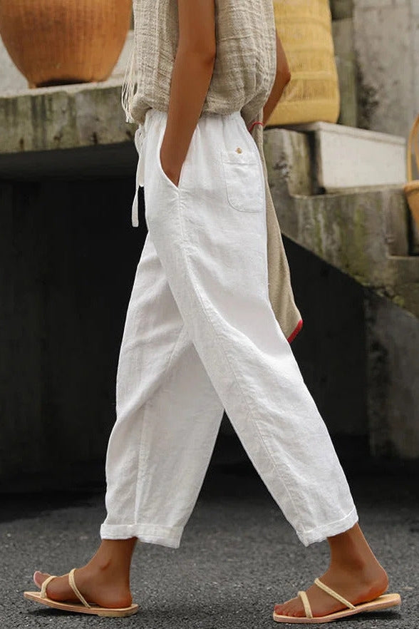 White relaxed wide leg trousers for women with a drawstring waist.
