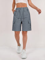 Olive green cargo shorts for women with a quick-dry fabric and multiple pockets, perfect for casual outdoor activities. 10