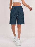 Olive green cargo shorts for women with a quick-dry fabric and multiple pockets, perfect for casual outdoor activities. 11