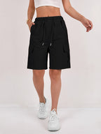 Olive green cargo shorts for women with a quick-dry fabric and multiple pockets, perfect for casual outdoor activities. 9