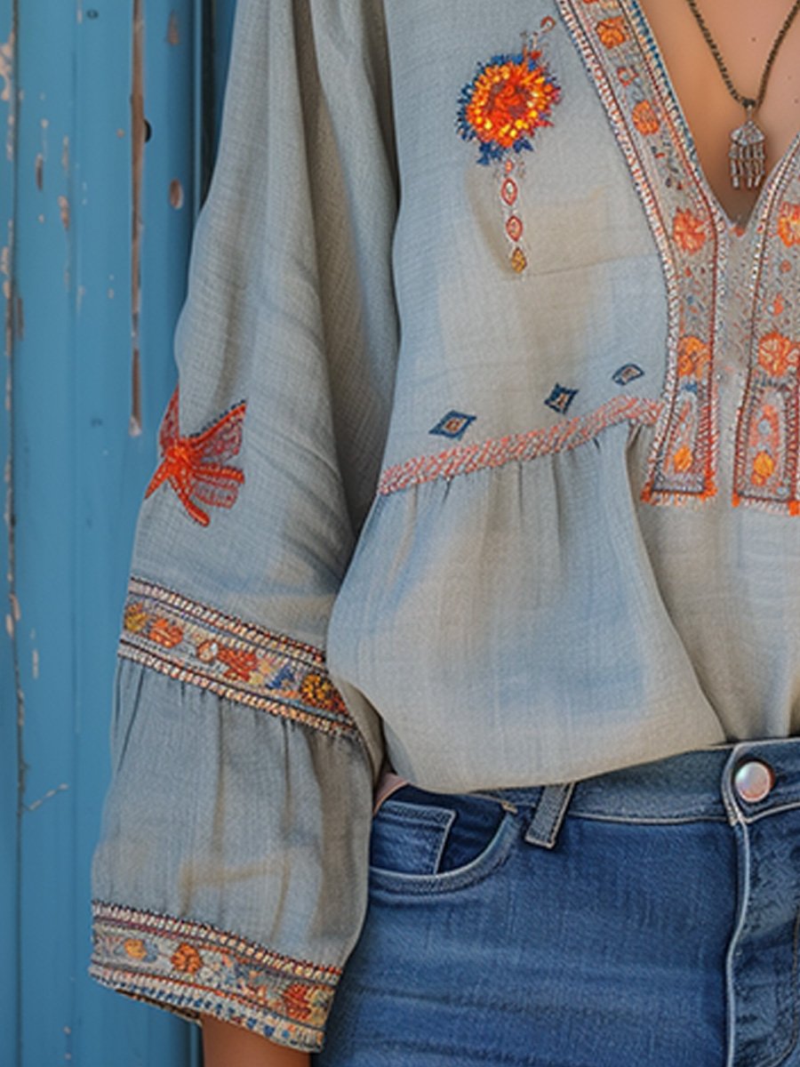 Flowy white bohemian blouse with delicate lace details and vibrant floral patterns. 3