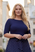Navy blue midi dress with white polka dots, flared skirt, and a waist tie detail. 2