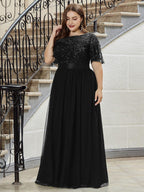 Plus size evening dress in deep blue, featuring embroidered details and elegant ruffle sleeves. Floor-length style. 12
