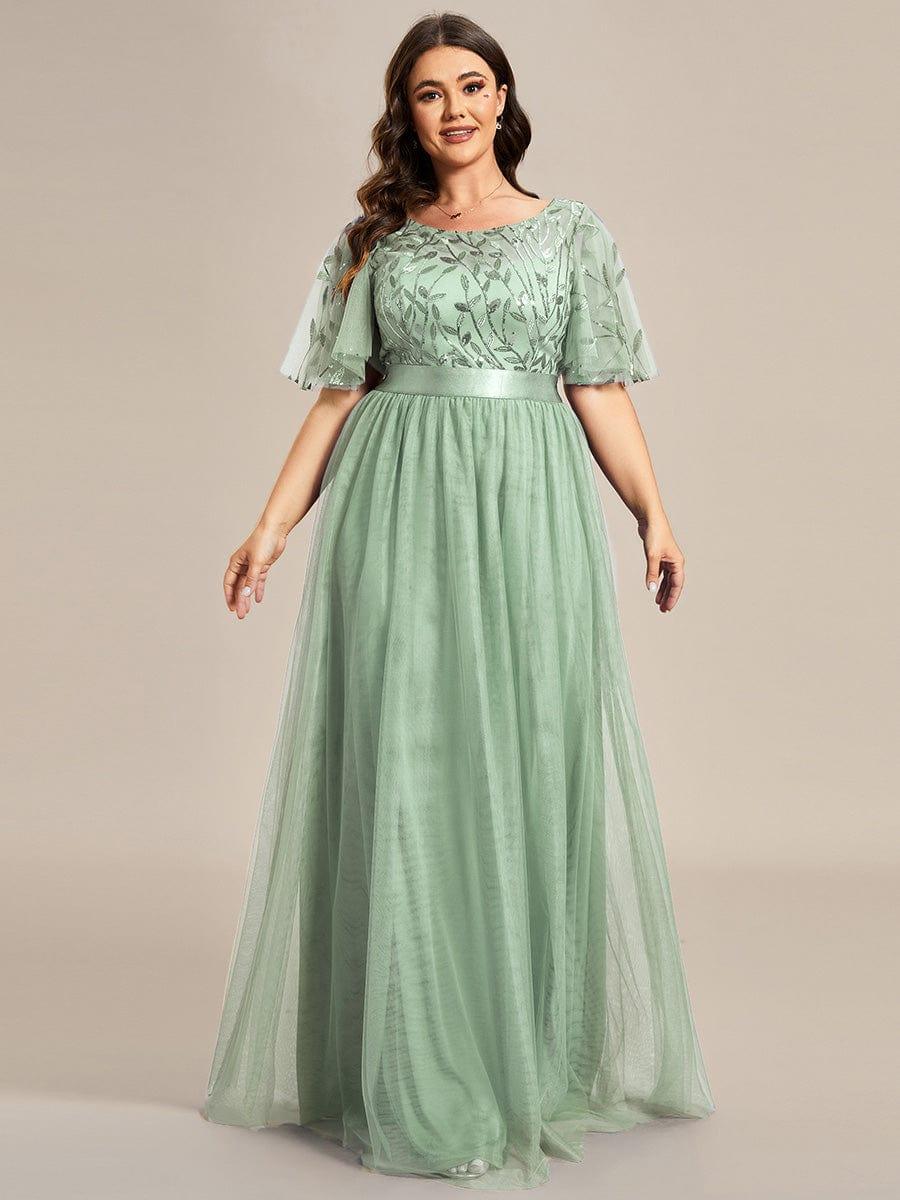 Plus size evening dress in deep blue, featuring embroidered details and elegant ruffle sleeves. Floor-length style. 13