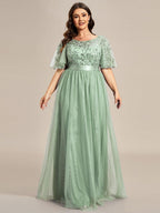 Plus size evening dress in deep blue, featuring embroidered details and elegant ruffle sleeves. Floor-length style. 13