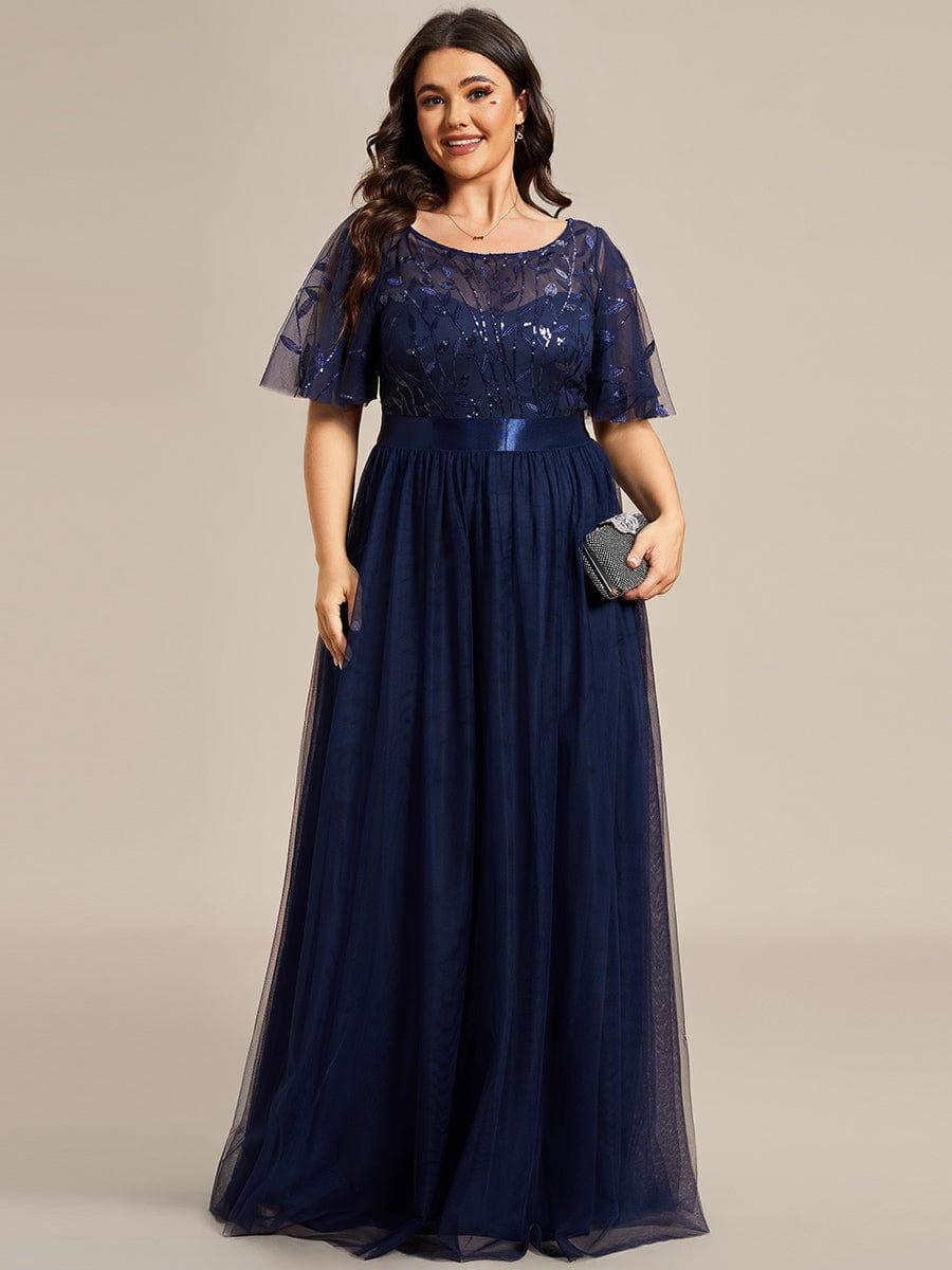Plus size evening dress in deep blue, featuring embroidered details and elegant ruffle sleeves. Floor-length style. 14